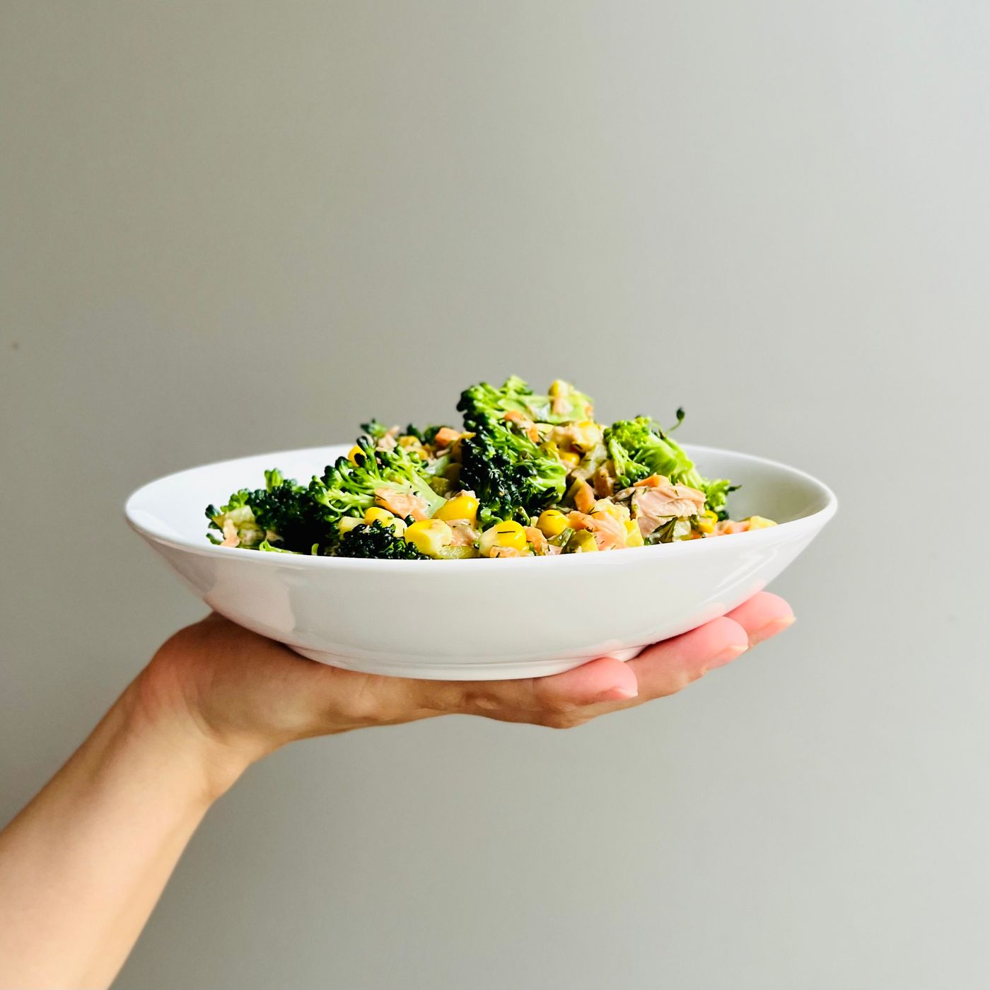 Broccoli & chickpea salad; broccoli florets, chickpeas, small dark seeds