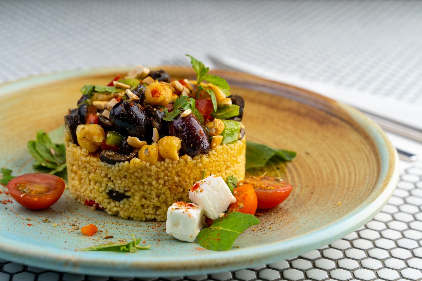 Mediterranean couscous with feta; golden couscous, chickpeas, dark olives, cherry tomato halves