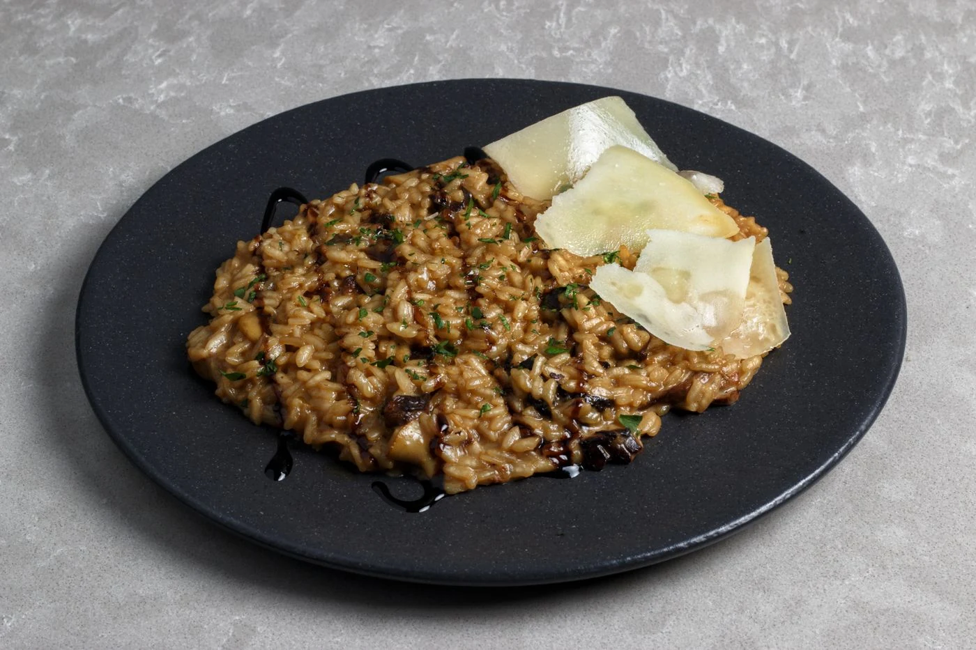 Mushroom risotto with parsley, hard-cheese shavings and balsamic drizzle
