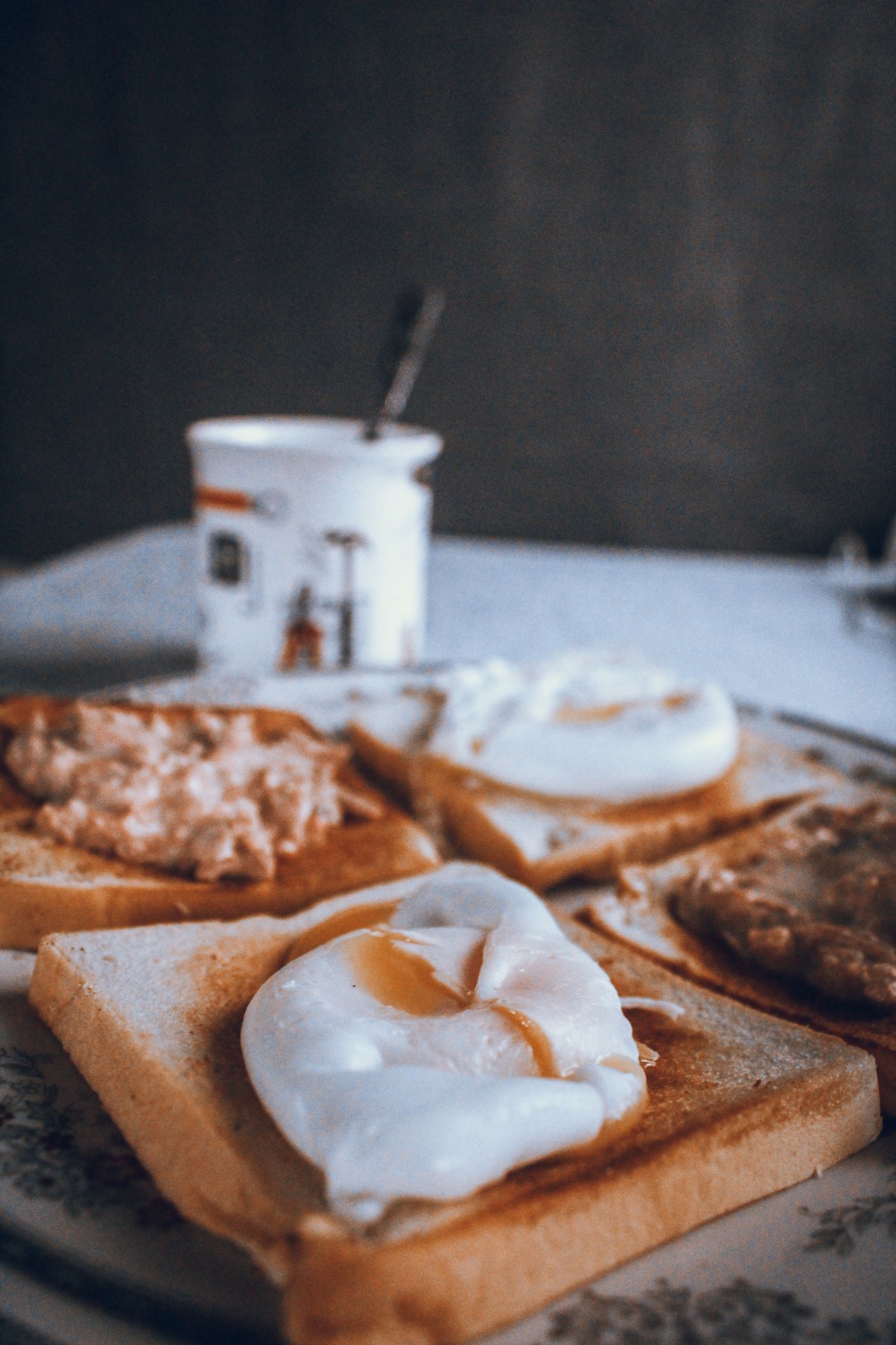 Poached eggs on toast with spread and coffee