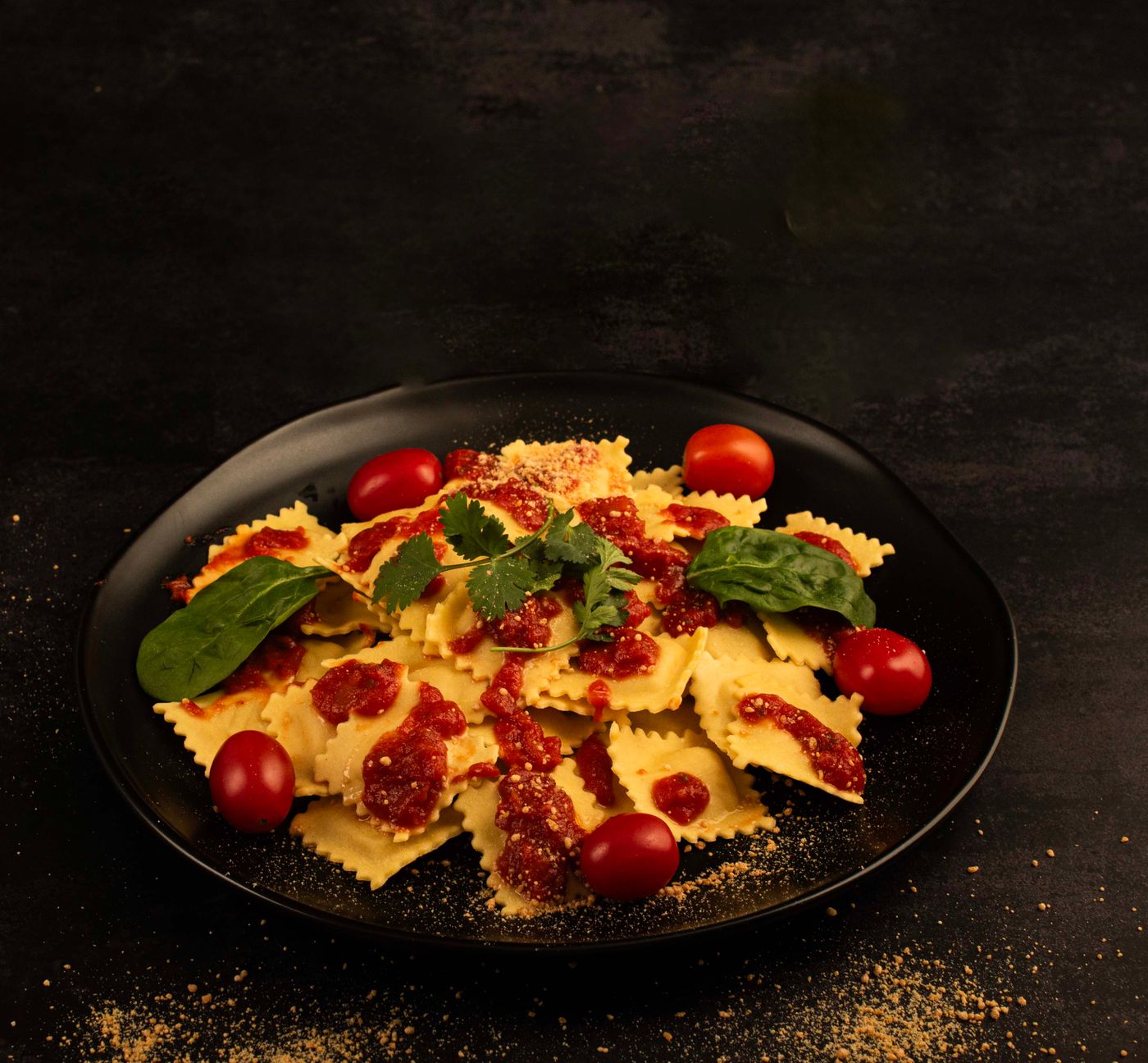 Tomato & spinach ravioli; square ravioli, red tomato sauce, whole cherry tomatoes, fresh spinach leaves